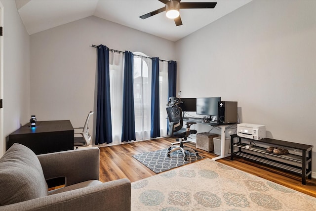 home office with hardwood / wood-style flooring, vaulted ceiling, and ceiling fan