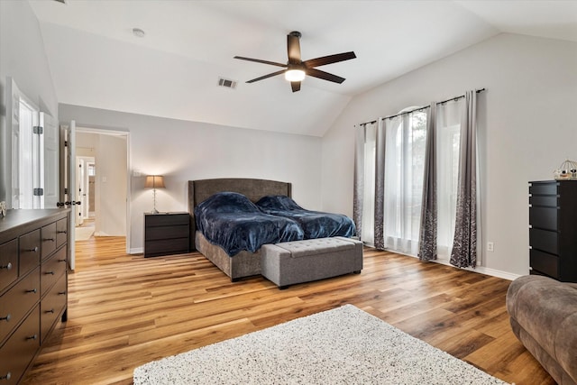 bedroom featuring ceiling fan, lofted ceiling, and light hardwood / wood-style floors