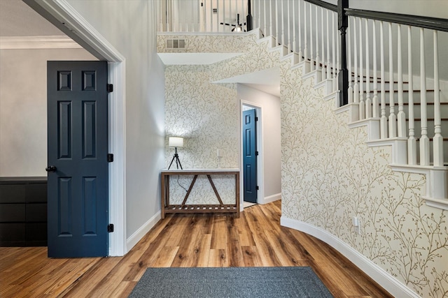 entryway featuring crown molding and wood-type flooring