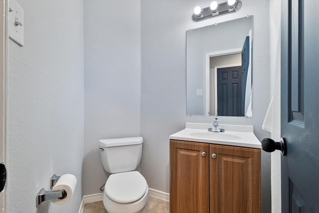 bathroom with vanity, tile patterned floors, and toilet