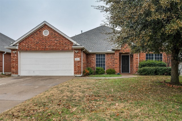 view of front of home with a garage and a front lawn