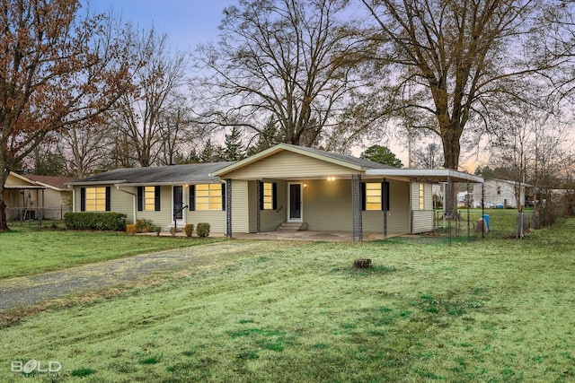 single story home with a lawn and a carport