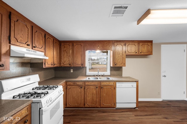 kitchen with sink, white appliances, dark wood-type flooring, and decorative backsplash