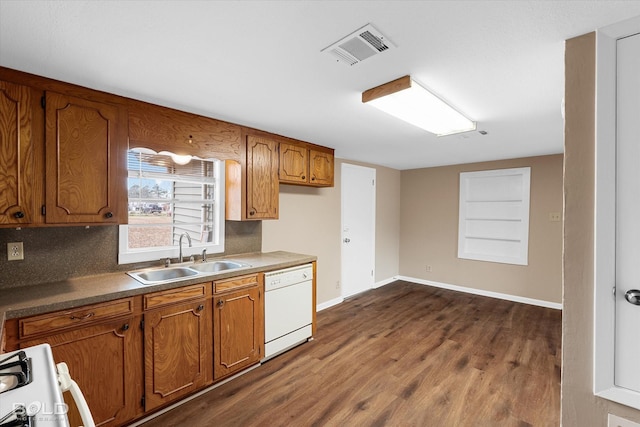 kitchen with dark hardwood / wood-style floors, sink, and white appliances