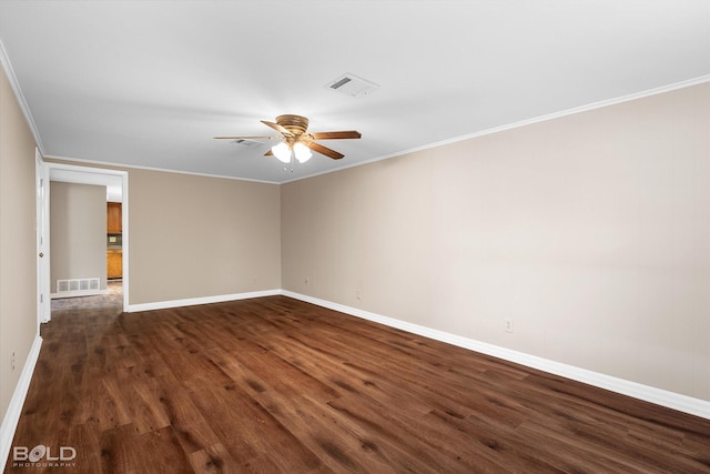 empty room with ornamental molding, ceiling fan, and dark hardwood / wood-style flooring