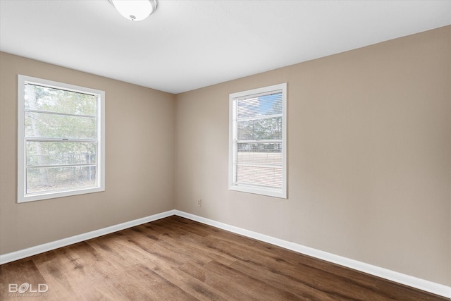 unfurnished room with hardwood / wood-style floors