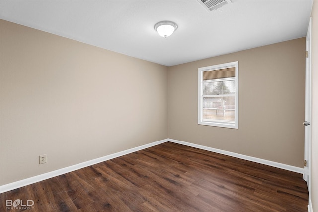 empty room with dark hardwood / wood-style floors