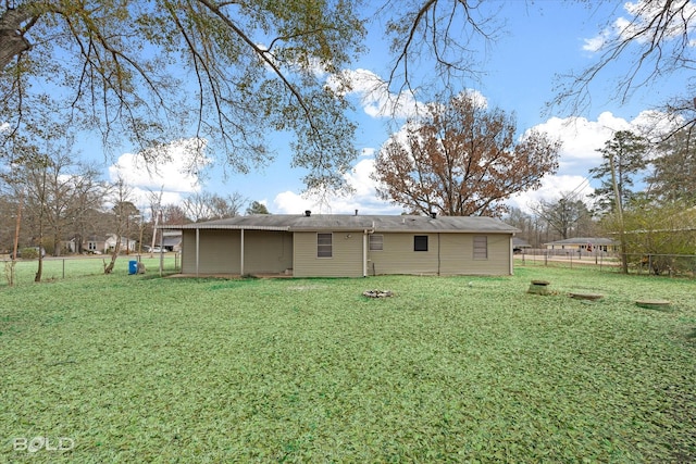 back of property with a lawn