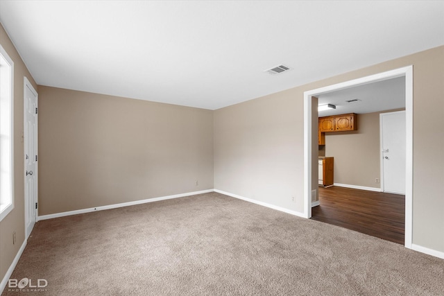 empty room with dark carpet