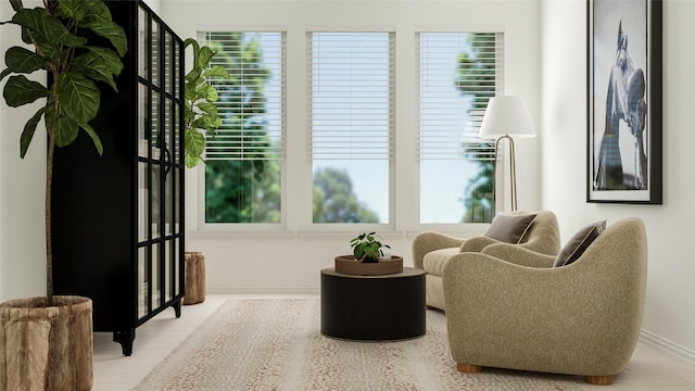 living area with hardwood / wood-style floors and a healthy amount of sunlight