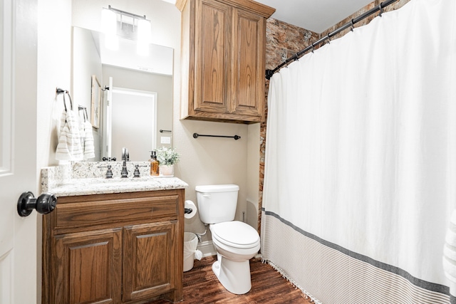 bathroom with hardwood / wood-style flooring, vanity, and toilet