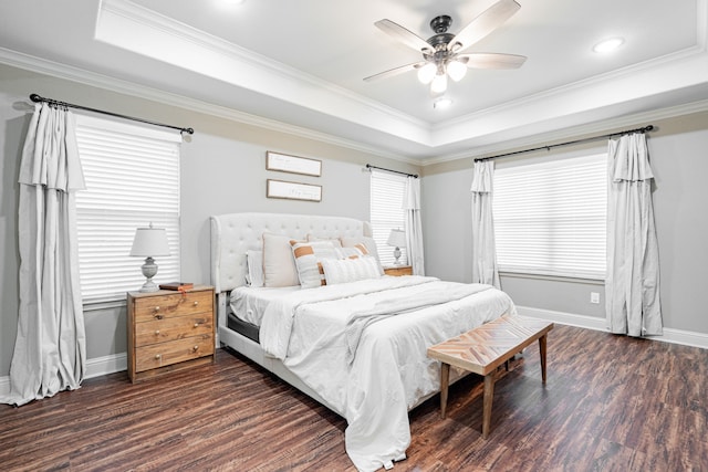 bedroom with ceiling fan, ornamental molding, a tray ceiling, and dark hardwood / wood-style flooring