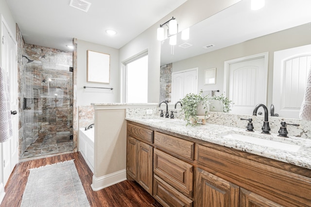 bathroom with vanity, hardwood / wood-style flooring, and separate shower and tub