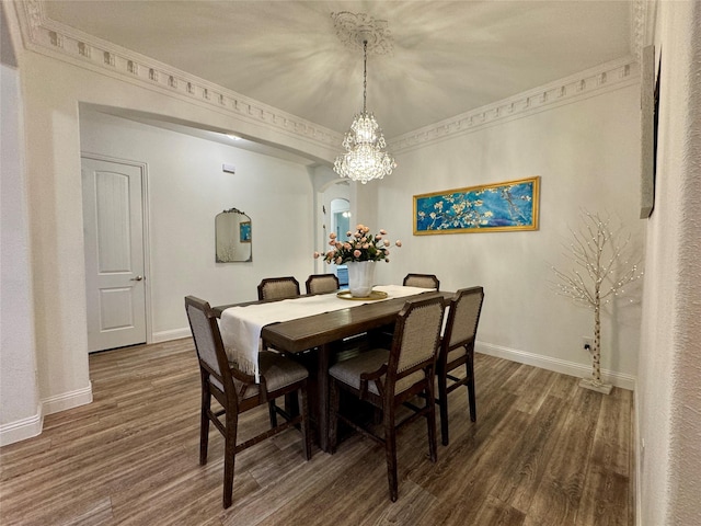 dining room with dark hardwood / wood-style flooring and ornamental molding