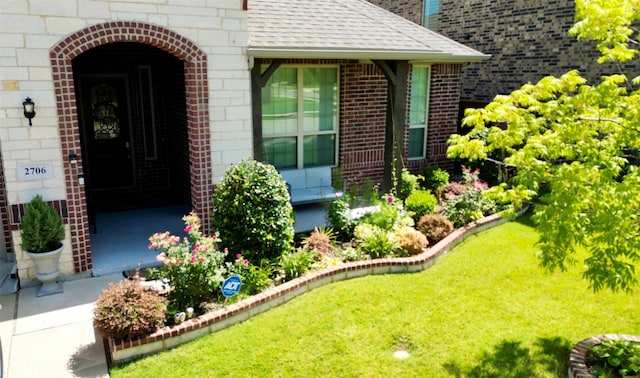 entrance to property featuring a yard