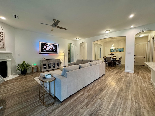 living room with hardwood / wood-style flooring and ceiling fan