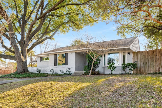 ranch-style home with a front yard