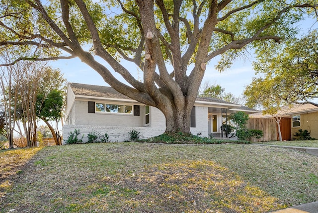 ranch-style house with a front lawn