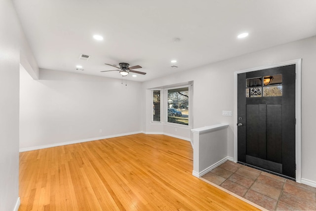 foyer featuring ceiling fan and wood-type flooring