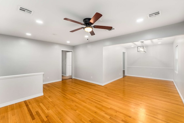 unfurnished room featuring ceiling fan and light hardwood / wood-style flooring