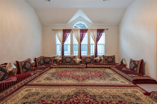 living area with visible vents and vaulted ceiling