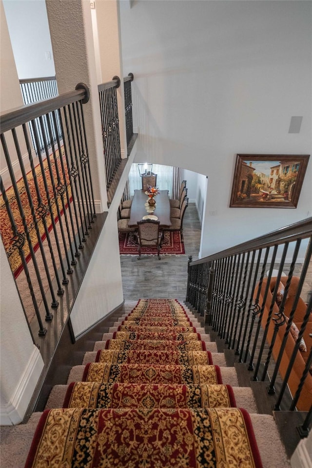 stairs with wood finished floors and baseboards