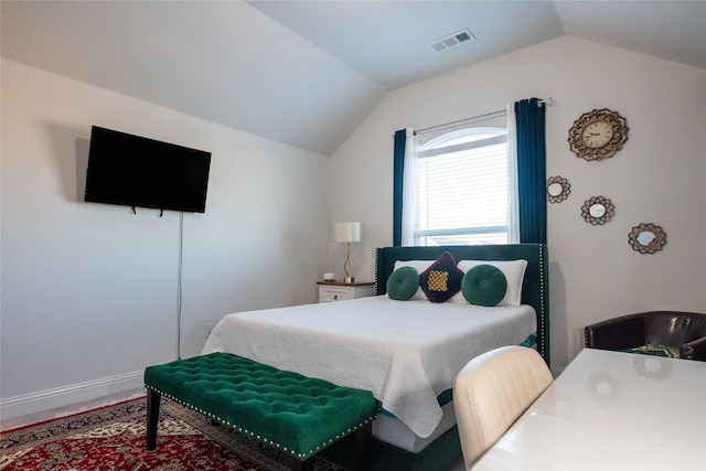 bedroom featuring lofted ceiling, baseboards, and visible vents