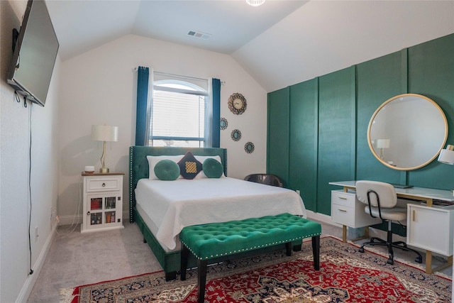 bedroom with lofted ceiling, visible vents, and light colored carpet