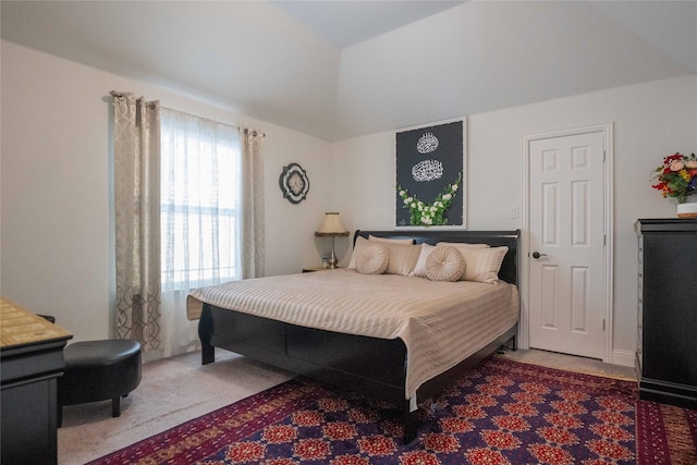 carpeted bedroom featuring lofted ceiling