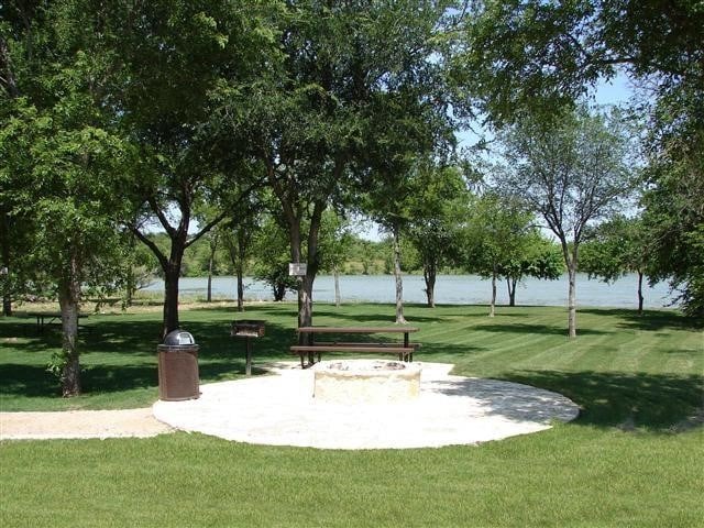 view of community featuring a water view and a lawn