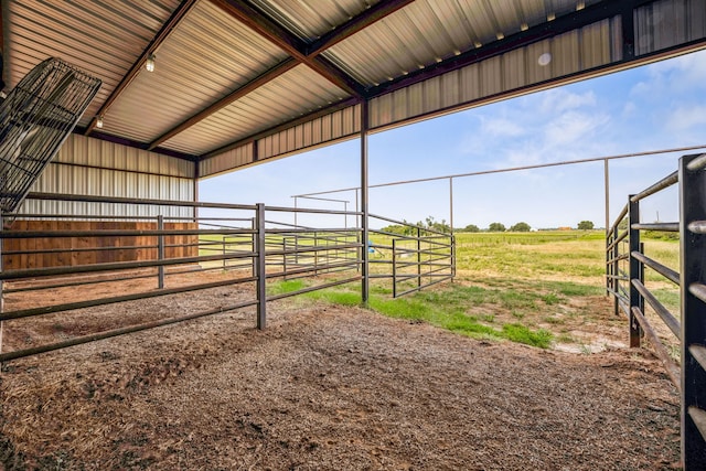 view of horse barn featuring a rural view