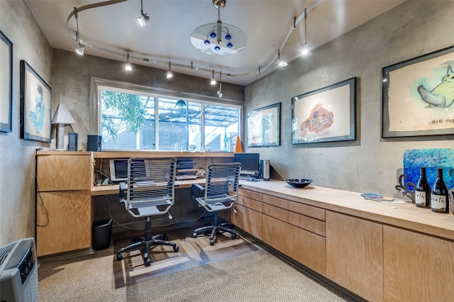 office area with built in desk and rail lighting