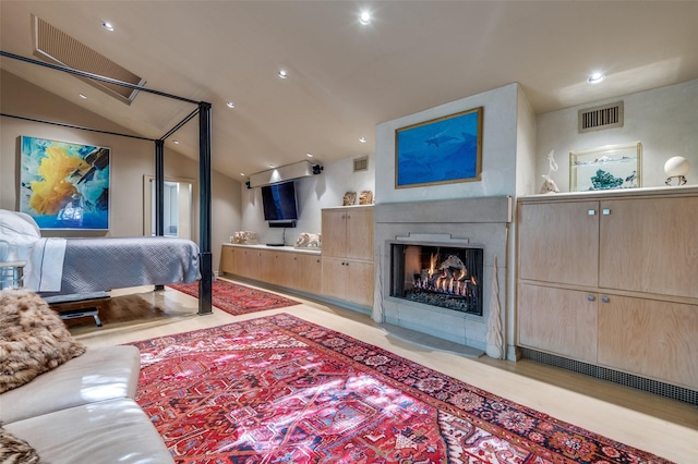 bedroom featuring lofted ceiling and light hardwood / wood-style flooring