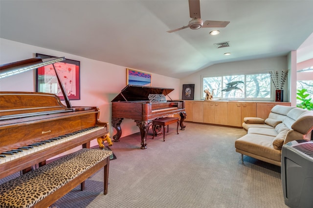 living area with vaulted ceiling, light carpet, and ceiling fan