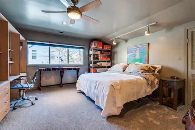 bedroom featuring vaulted ceiling, ceiling fan, rail lighting, and carpet floors