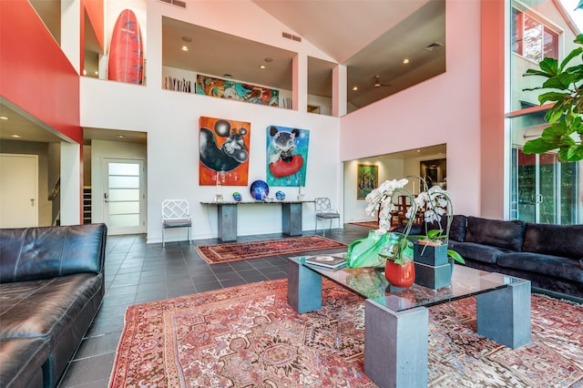 tiled living room featuring high vaulted ceiling