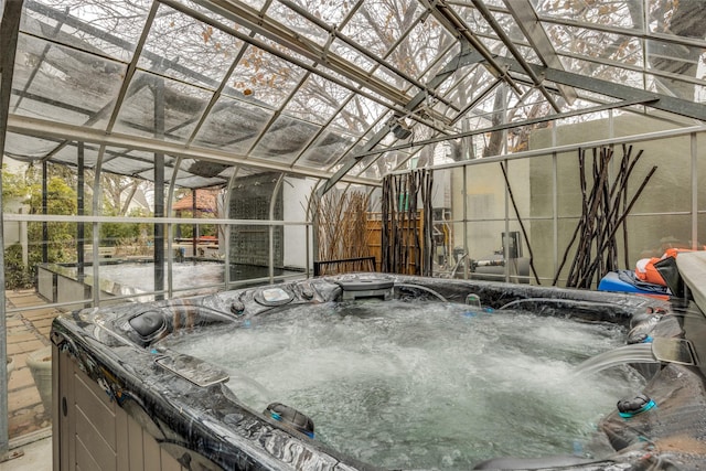 exterior space featuring a jacuzzi and vaulted ceiling