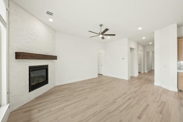 living room with ceiling fan and light wood-type flooring