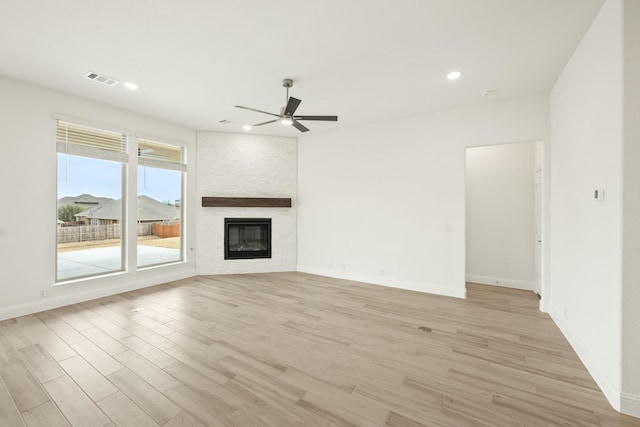 unfurnished living room with a fireplace, light wood finished floors, recessed lighting, a ceiling fan, and baseboards