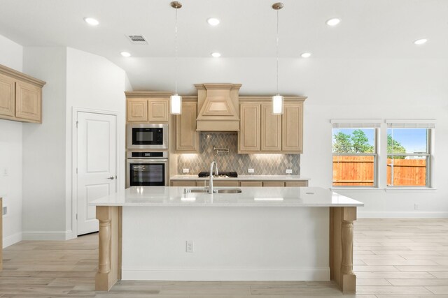 kitchen with lofted ceiling, stainless steel appliances, sink, and decorative backsplash