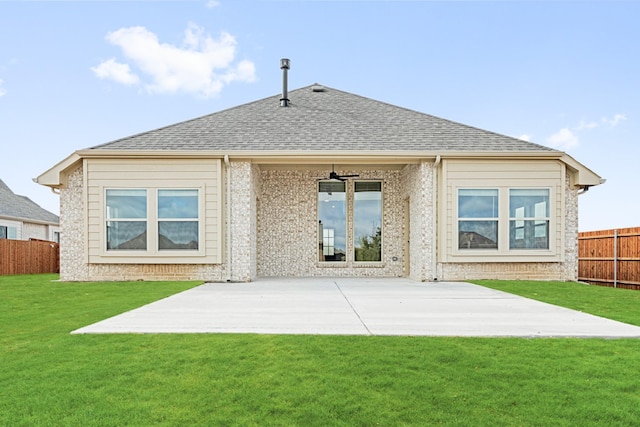 back of property featuring a patio, a shingled roof, a lawn, a ceiling fan, and fence