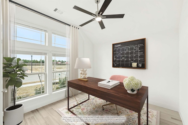 office area with ceiling fan, light wood-type flooring, visible vents, and baseboards