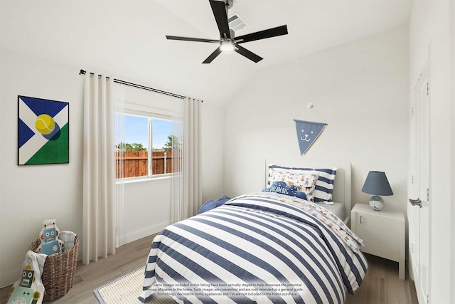 bedroom featuring lofted ceiling, visible vents, ceiling fan, and light wood-style flooring