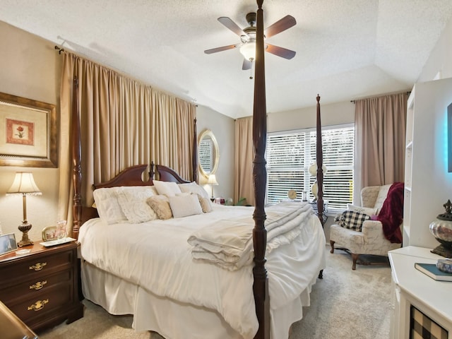 bedroom featuring light carpet, vaulted ceiling, a textured ceiling, and ceiling fan