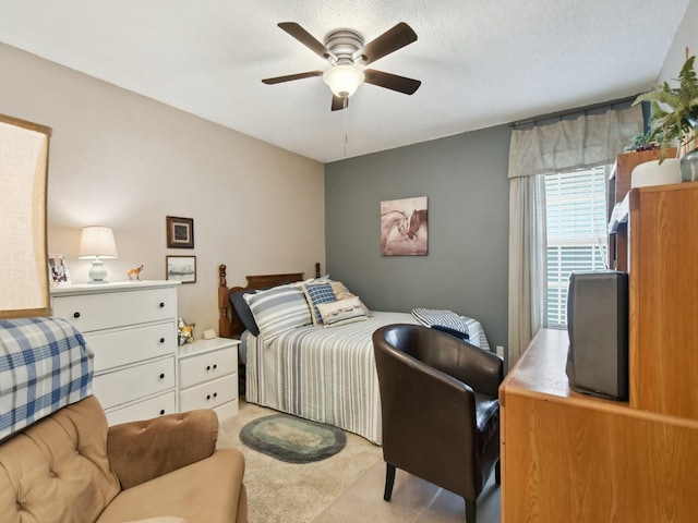 bedroom featuring ceiling fan and light carpet