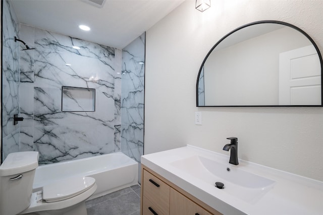 full bathroom featuring tiled shower / bath combo, vanity, and toilet