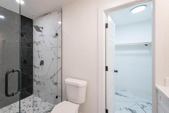 bathroom with vanity, a shower with shower door, and toilet