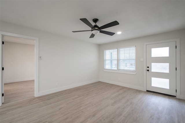 foyer with ceiling fan and light hardwood / wood-style flooring