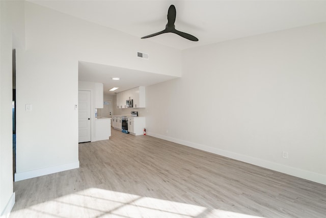 unfurnished living room featuring ceiling fan and light wood-type flooring