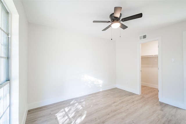 spare room featuring ceiling fan and light hardwood / wood-style flooring